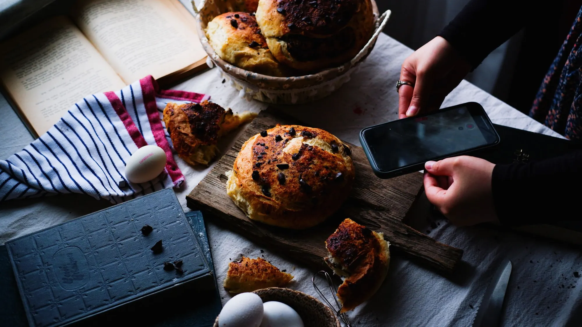 A phone on a table beside fresh bakes